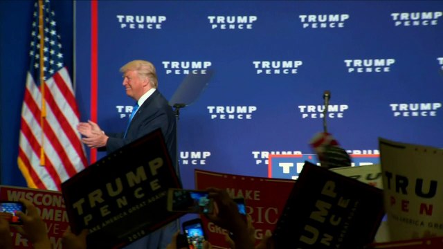 Trump shrugs off polls, implies voter fraud at rally