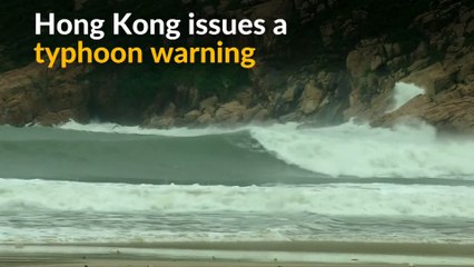 Surfers ride typhoon waves in Hong Kong