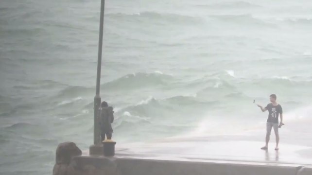 Locals Risk Typhoon Conditions for Snaps at Hong Kong Port