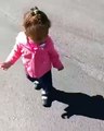 A little boy awe by his won shadow