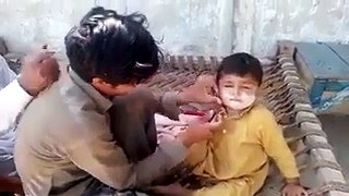 kids geting shave in pakistani village
