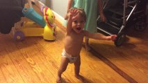 Baby screams with excitement while taking very first steps