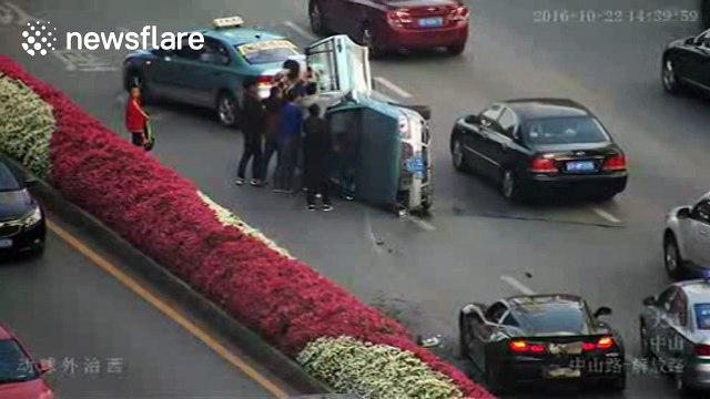 Taxi knocked over by sports car while changing lane