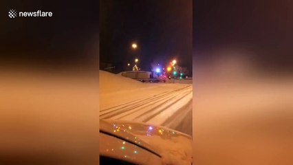Car overturns while sliding on snowy road