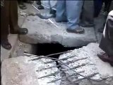 Indian People tease woman stuck in concrete at road