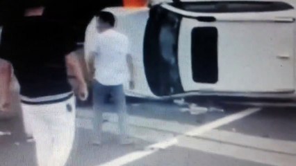 Heroic passersby save couple trapped inside burning car on the highway.