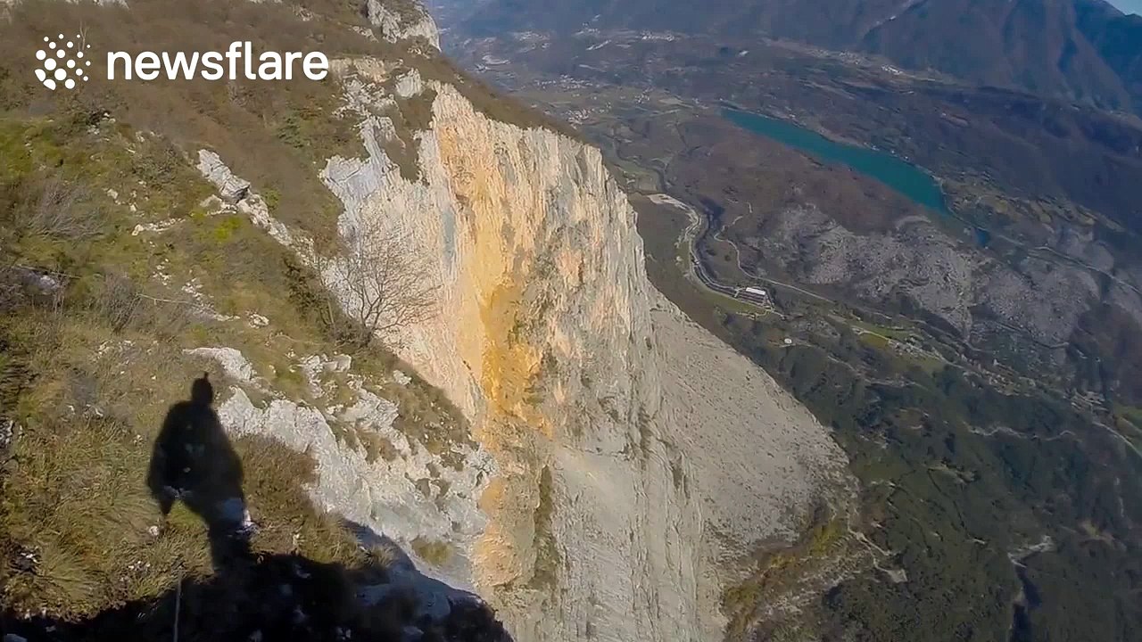 Thrilling point of view footage of wingsuit BASE jump