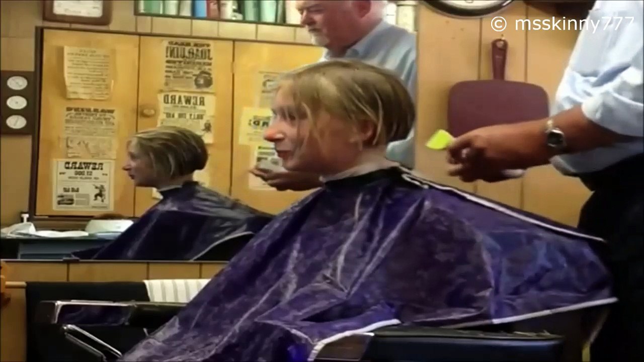 girl gets her nape shaved at the barbershop