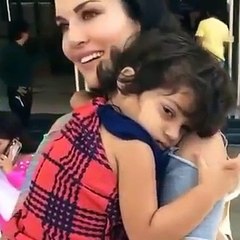 So Cute! - A little fan refusing to leave Sunny Leone at a recent event.