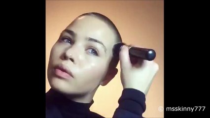 beautiful bald girl doing her makeup