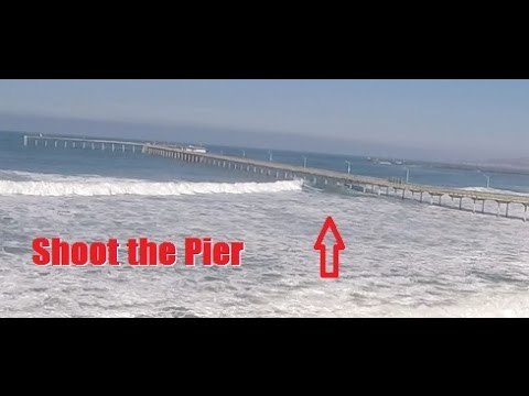 Daring Surfers Shoot the Ocean Beach Pier in San Diego During High Surf
