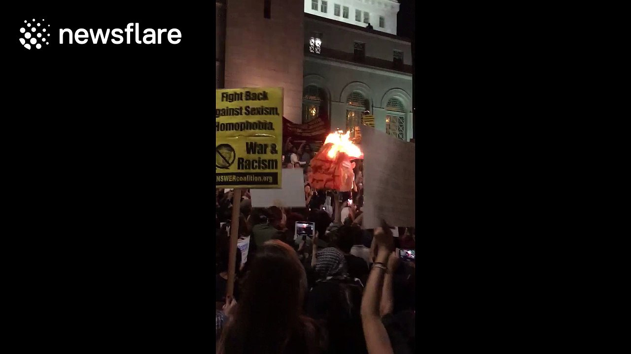 Protesters burn Donald Trump effigy