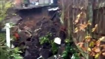 Homes evacuated after large sinkhole opened up behind row of house