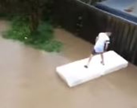Boys Ride Mattress Through Post-Quake Flooded Wellington