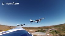 Pilots perform stunts with chained aircrafts