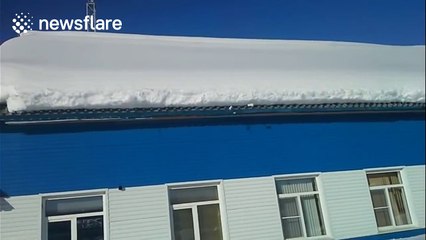 Massive amount of snow falls off roof