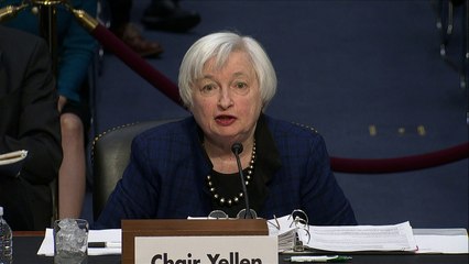 Fed's Yellen vows to serve out term, signals rate hike