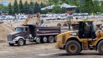 Double Dump Truck and loader with forklift attachment working