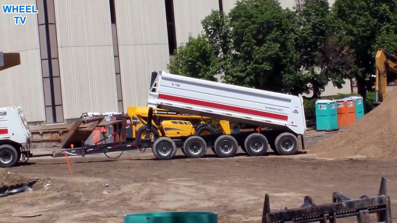 Double Dump Truck back end dumping in a huge pile of soil