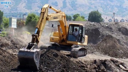 Komatsu PC220 LC Excavator working a big pile of dirt differnt angle