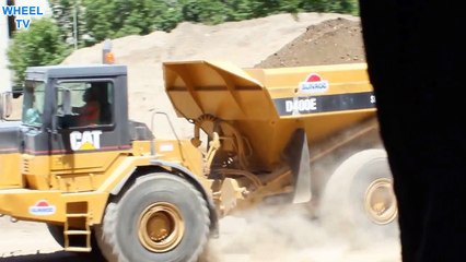 CAT D400 Dump truck driving and dumping load