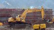 Komatsu PC220 Excavator moving dirt from pile to pile