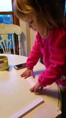 Enthusiastic toddler prepares Christmas cards