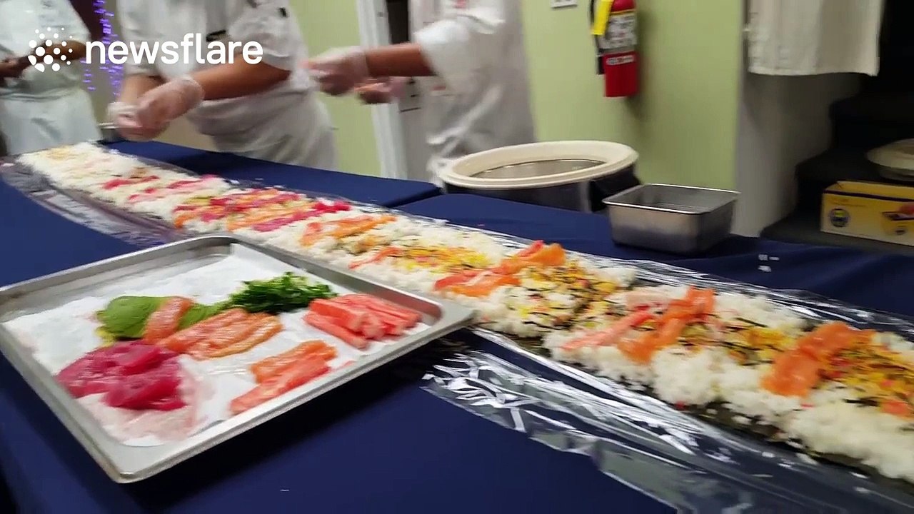 Sushi chefs produce giant sushi roll