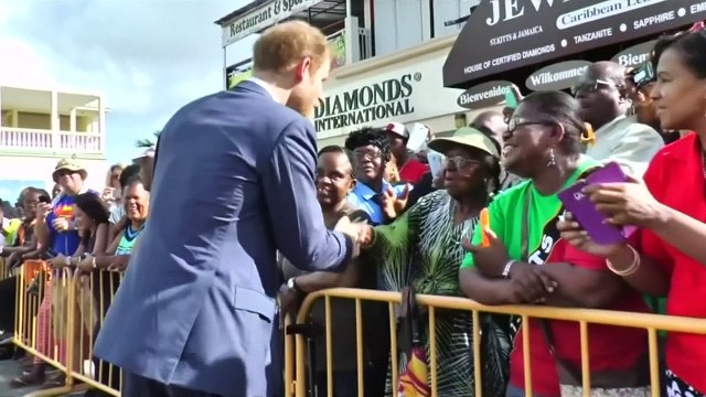 Little girl offers Prince Harry drawing in St Kitts & Nevis