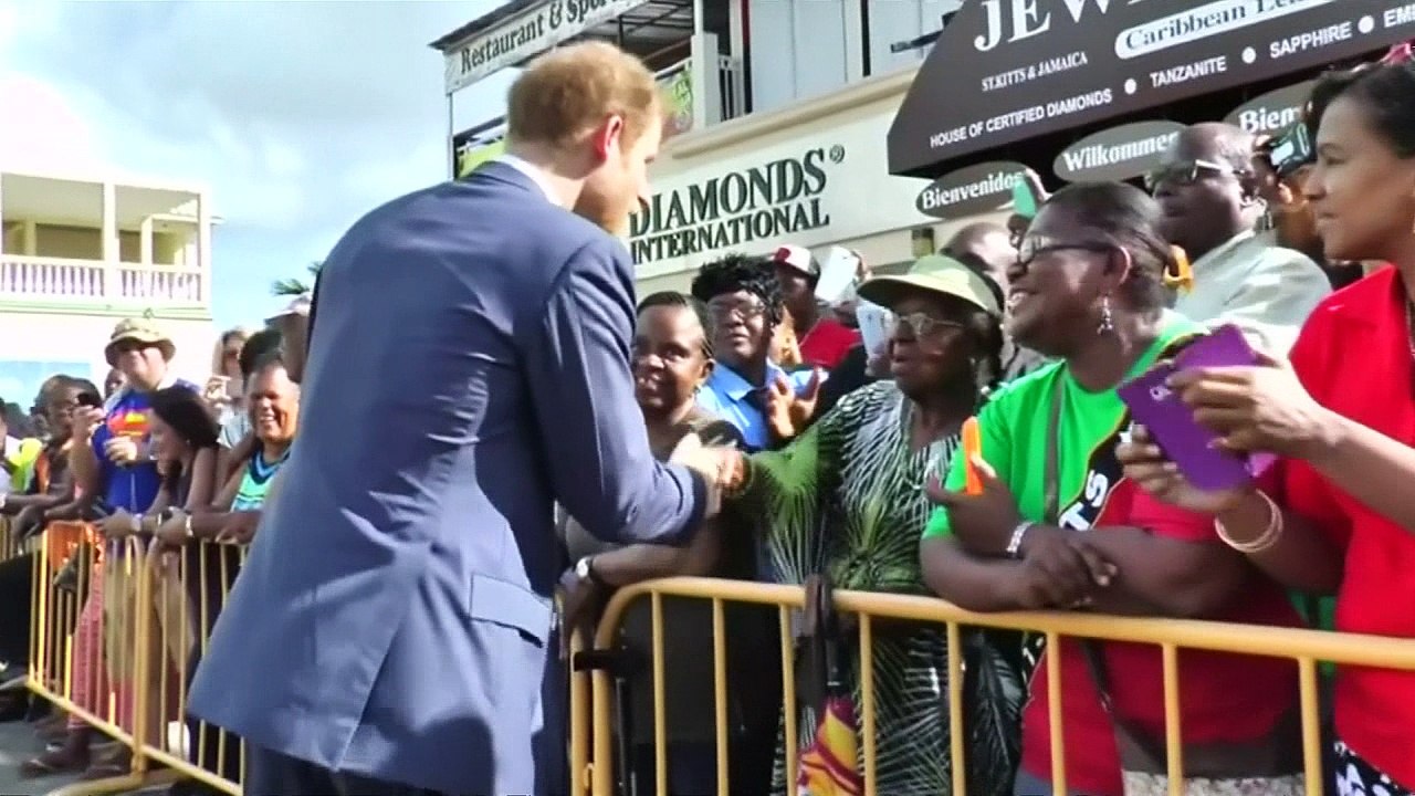 Little girl offers Prince Harry drawing in St Kitts & Nevis