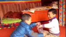 Two Tibetan kids playing an extreme game of Rock-Paper-Scissors.