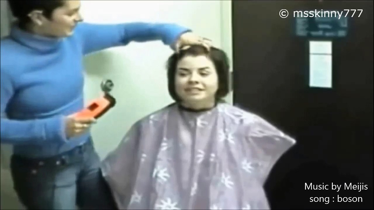 one girl shaves another girl's hair off