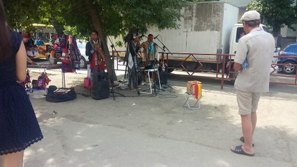 Strolling musicians from Cuba play on the sidewalk in Russia