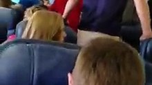 Soldier About To Exit Plane With Remains Of Fallen Hero, Student Passengers Stand In Impromptu Song