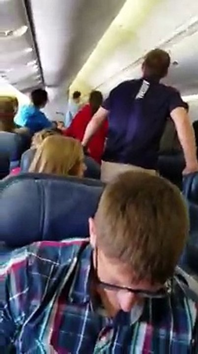 Soldier About To Exit Plane With Remains Of Fallen Hero, Student Passengers Stand In Impromptu Song