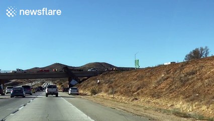 18-wheeler truck falls off bridge onto California highway