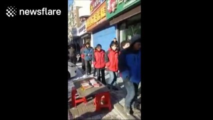 Bakery staff crawl on snow-covered street after failing to hit targets