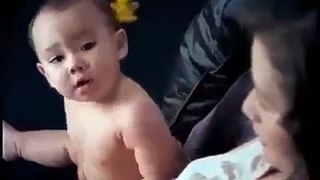 Funny cute baby gives diaper to his mom