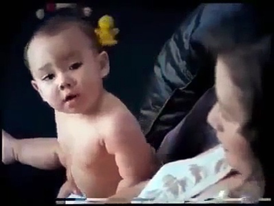 Funny cute baby gives diaper to his mom