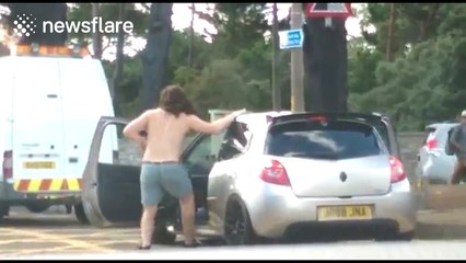 Shirtless man gets out of car to entertain drivers stuck in traffic jam