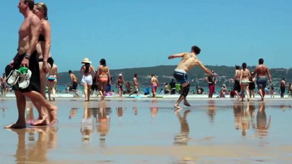 Slow motion aerobic beach stunts in Sydney