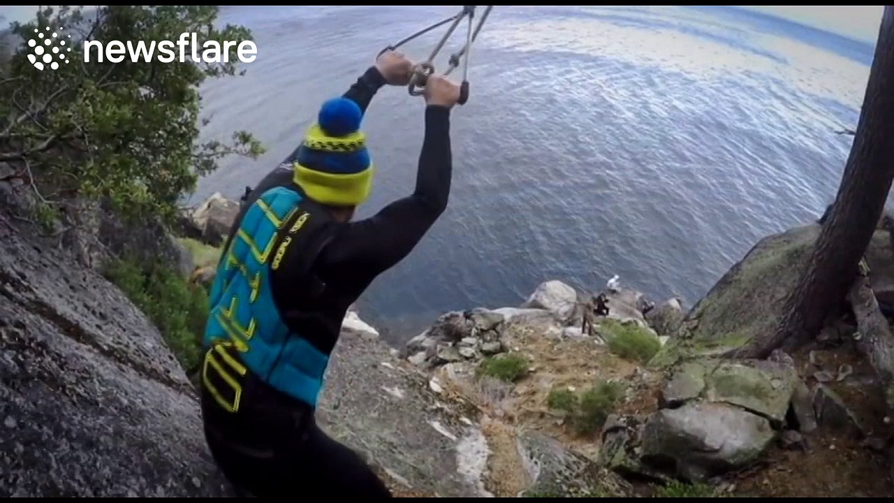 Impressive double backflip jump from huge rope swing