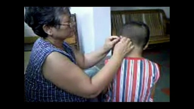 Chinese Ear Cleaning (53) A grandmother cleaning her grandson's ears