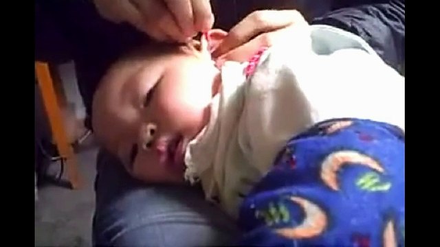 Chinese Ear Cleaning (72) A mother cleaning her daughter's ears
