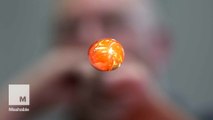 These artists blow air in molten glass to make beautiful Christmas ornaments