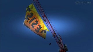 Greenpeace activists unfurl 'Resist' banner atop of crane near White House