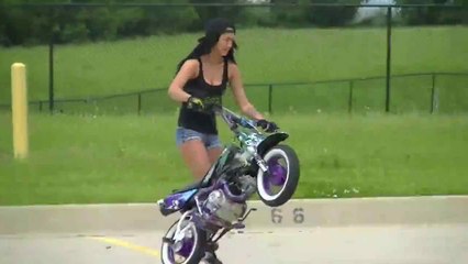 Girl Doing One Wheeling On Bike