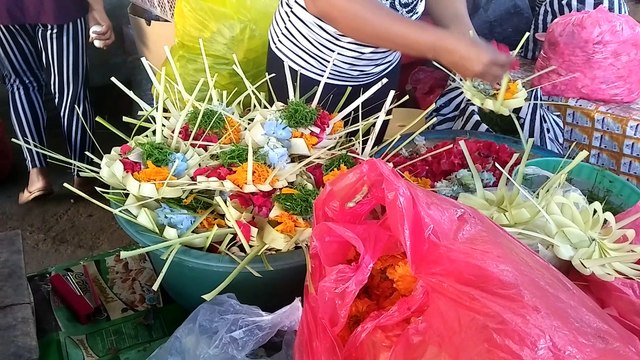 arranging flowers for offerings in bali