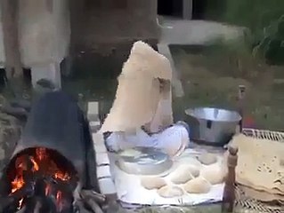 Man Cooking Large Size Of Bread