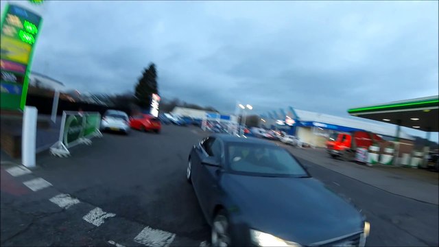 car drives at cyclist